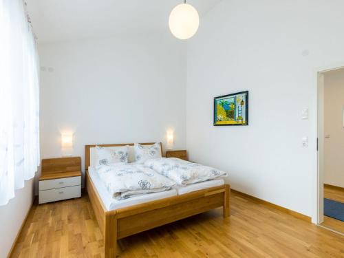 a bedroom with a bed in a white room at Beech Modern Retreat in Hödingen
