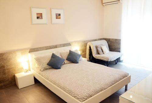 a small bedroom with a bed and a chair at Apartments Marjana in Portorož