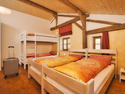 a bedroom with two bunk beds and a suitcase at Oberprill Modern retreat in Loitzendorf