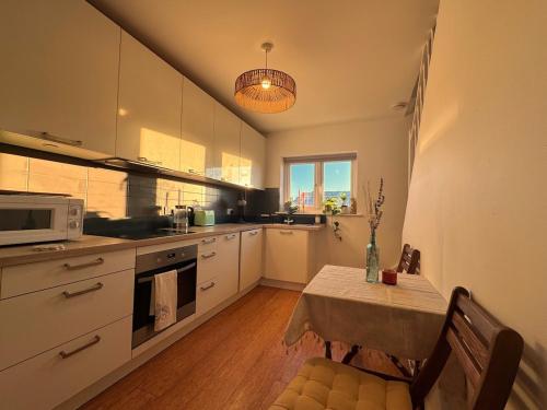a kitchen with a table and a microwave at Central Brighton 2 Bed House in Brighton & Hove
