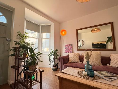 a living room with a couch and a mirror at Central Brighton 2 Bed House in Brighton & Hove