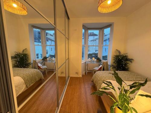 a bedroom with two beds and a large mirror at Central Brighton 2 Bed House in Brighton & Hove