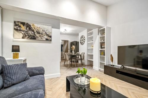 a living room with a couch and a table at Luxury Cozy 2 bed house hot tub family friendly business traveler family of 4 - 6 with parking close to Birmingham city centre , M6 , Aston univerity , Great Barr Birmingham in Birmingham