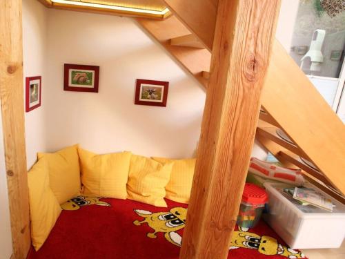 a childs room with a bunk bed under a stairs at Holiday home chalet on the castle hill in Brotterode-Trusetal