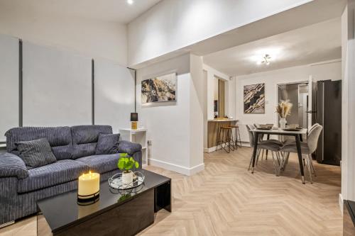 a living room with a couch and a table at Luxury Cozy 2 bed house hot tub family friendly business traveler family of 4 - 6 with parking close to Birmingham city centre , M6 , Aston univerity , Great Barr Birmingham in Birmingham