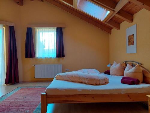 a bedroom with a large bed with white sheets and pillows at Michls Villa Modern retreat" in Tarrenz