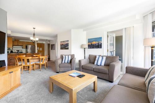 a living room with a couch and a table at The Woodrun Lodge by Whiski Jack in Whistler