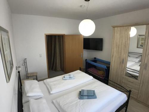 a room with two beds and a mirror at Holiday apartment on the Anger in Wernigerode