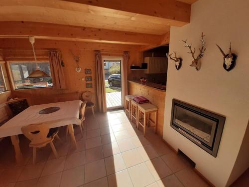 a kitchen and dining room with a table and a fireplace at Alpenglöckchen Comfortable holiday residence in Stadl an der Mur