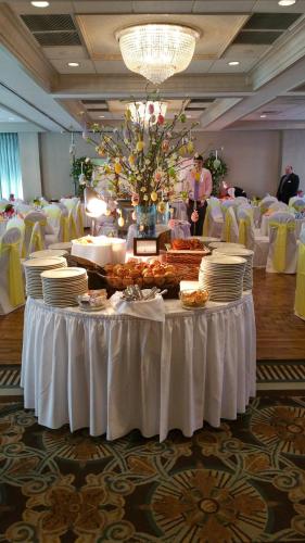 a table with plates of food on it in a room at Salem Waterfront Hotel & Suites in Salem