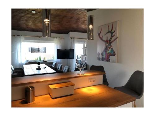 a living room with a desk and a living room with at Villa Alpenblick Comfortable holiday residence in Füssen