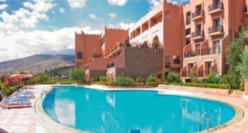 a large swimming pool in front of a building at Chems Du Lac Bin El Ouidane in Bine el Ouidane