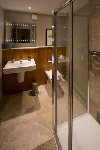 a bathroom with a shower and a sink and a toilet at Cotswold Grey in Moreton in Marsh