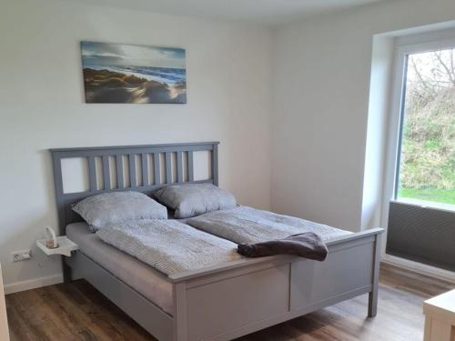 a bed in a bedroom with a window at Holiday home Stieglund in Jörl