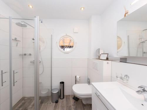 a white bathroom with a shower and a toilet at The Waldhaus Modern retreat in Neerdar