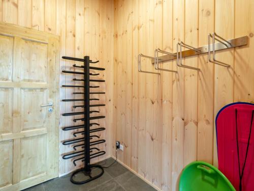 a room with a wooden wall with a rack at Holzchalet Tauplitz in Tauplitz