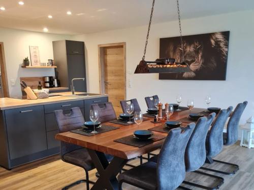 a dining room with a wooden table and chairs at Holiday home Stieglund in Jörl