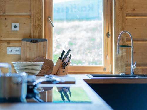 a kitchen counter with a sink and a window at Holzchalet Tauplitz in Tauplitz