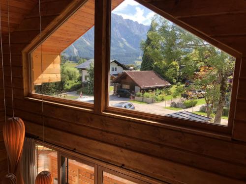 a window in a house with a view of a mountain at Holzchalet Tauplitz in Tauplitz