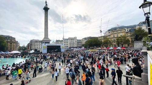 a large crowd of people standing around a fountain at Hotel Indigo London - 1 Leicester Square by IHG in London