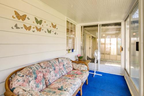 a living room with a couch and a window at Cleveland Heights Home with Sunroom Park Across St! in Cleveland Heights