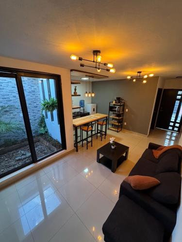 a living room with a couch and a table at Casas Victoria in San Cristóbal de Las Casas