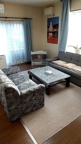 a living room with a couch and a table at 10-minute walk from Hakodate station, entire house, up to 10 people in Hakodate