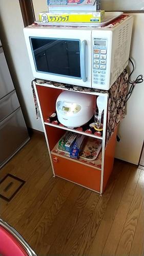 a microwave oven sitting on top of a shelf at 10-minute walk from Hakodate station, entire house, up to 10 people in Hakodate