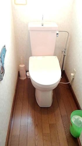 a white toilet in a bathroom with a wooden floor at 10-minute walk from Hakodate station, entire house, up to 10 people in Hakodate