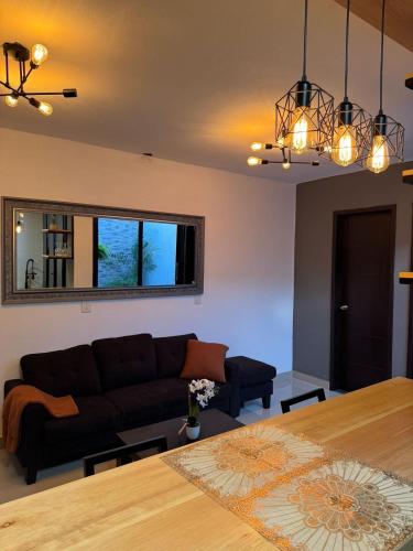 a living room with a couch and a table at Casas Victoria in San Cristóbal de Las Casas