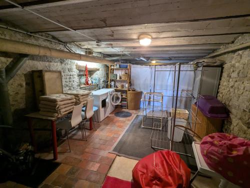 a room with a kitchen with a table and chairs at Maison XVIIIe avec jardin privatif - Yèvre le Châtel - FR-1-590-440 in Yèvre-la-Ville