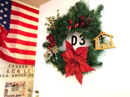 a christmas wreath next to an american flag at Lydia Enoch Sweet Family in Renton