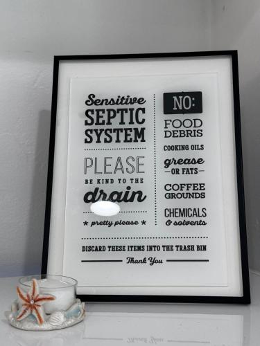 a framed picture of a sign on a shelf at Palm Beach Paradise in West Palm Beach