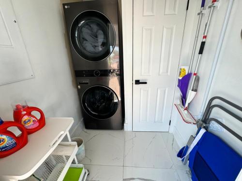 a washer and dryer sitting next to a door at Palm Beach Paradise in West Palm Beach