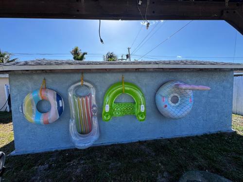 a wall with three different kinds of toys on it at Palm Beach Paradise in West Palm Beach