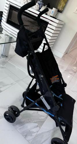 a stroller sitting on the floor next to a table at Palm Beach Paradise in West Palm Beach
