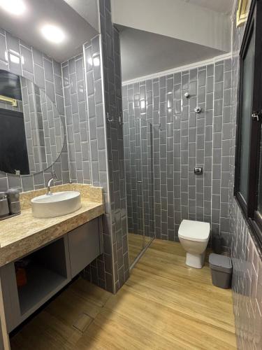 a bathroom with a sink and a toilet at Kitnet 1109 in São Vicente