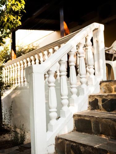 a staircase with white railings on a house at Areti Orfeas Studios in Vasilikos