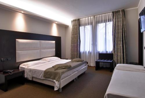 Postel nebo postele na pokoji v ubytování Hotel Villa Pannonia