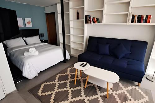 a bedroom with a bed and a blue couch at Casona Presa Sanalona No. 12 in Mexico City