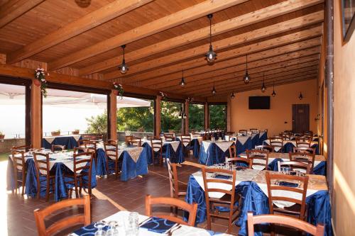 a banquet hall with tables and chairs with blue tables at Agriturismo La Molara in Sessa Aurunca