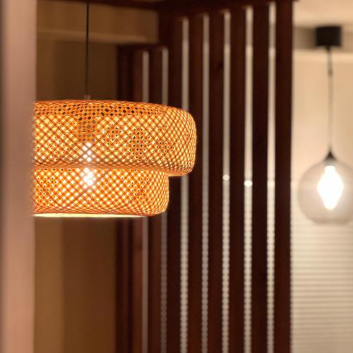 an orange pendant light hanging from a ceiling at Shiki Villa Beppu in Beppu