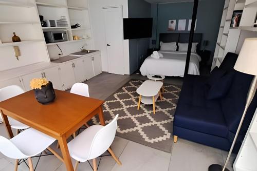 a bedroom with a bed and a table and chairs at Casona Presa Sanalona No. 12 in Mexico City