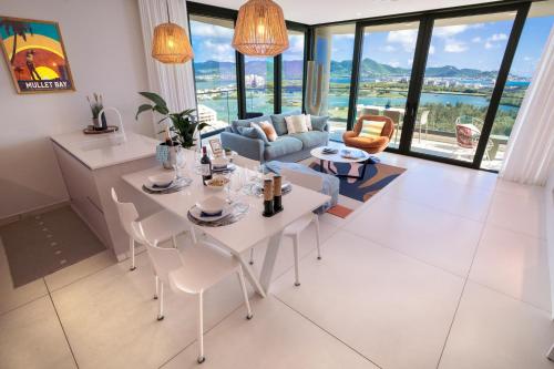 a living room with a table and chairs at Gorgeous 2 bedroom, 17th floor, with breathtaking view, Fourteen at Mullet Bay in Cupecoy