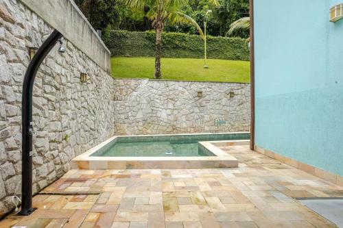 a swimming pool in a stone wall with a stone wall at Mansão Santa Tereza delux in Rio de Janeiro