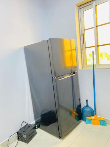 a glass refrigerator in a room with a window at The Blue Resort in Yaoundé