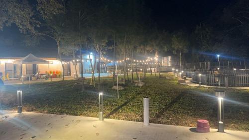 a park lit up at night with street lights at 祥宜三合院 in Guoxing