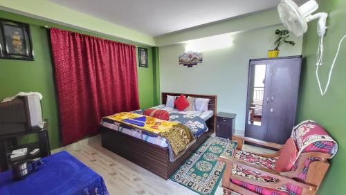 a bedroom with a bed and a chair in it at Seven Hills Homestay in Kalimpong