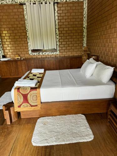 a bedroom with a large bed and a window at OHEI in Tangalle
