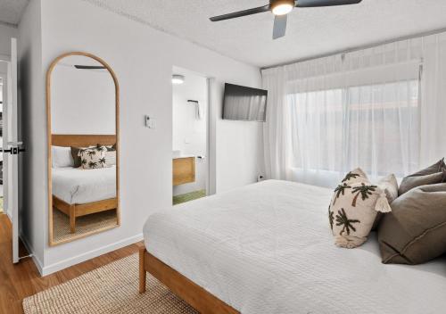 a bedroom with a bed and a large mirror at Ali's Waterfront Escape - Relaxing Getaway, Near Kirra Beach in Tweed Heads